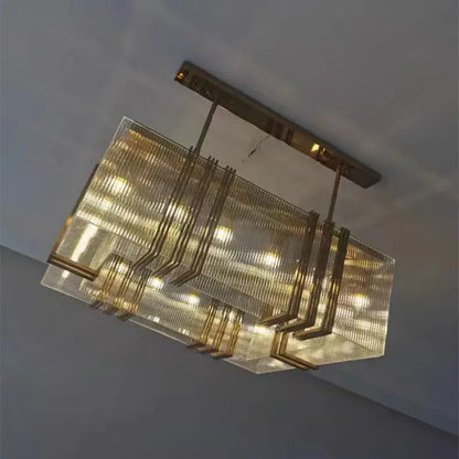 A gold lustre steel pendant light with rectangular gold-toned frame and textured glass panels for dining room decorbites gold lustre