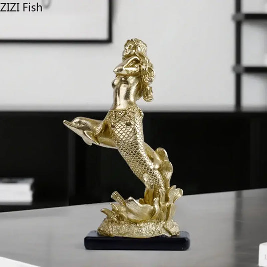 Golden mermaid statue resin sculpture with detailed scales and flowing hair standing atop a dolphin ornament