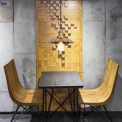 A warm-toned brass decorbites gold retro edison pendant light with a fluted petal shade above a dining table set