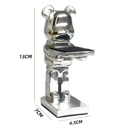 Silver metallic bear statue watch rack holding a black rectangular tray for bedroom storage and display
