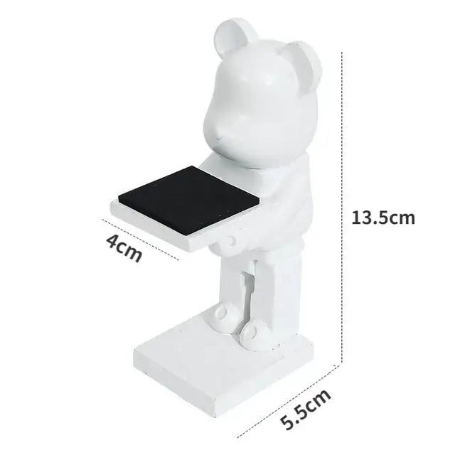 White bear statue watch rack with black rectangular surface held by outstretched arms for bedroom storage