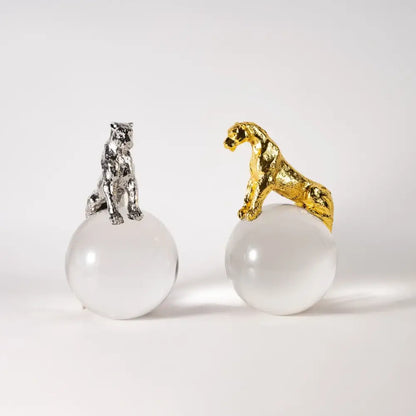 Two metallic panther figurines in gold and silver perched on translucent spheres for leopard crystal ball decorbites decor