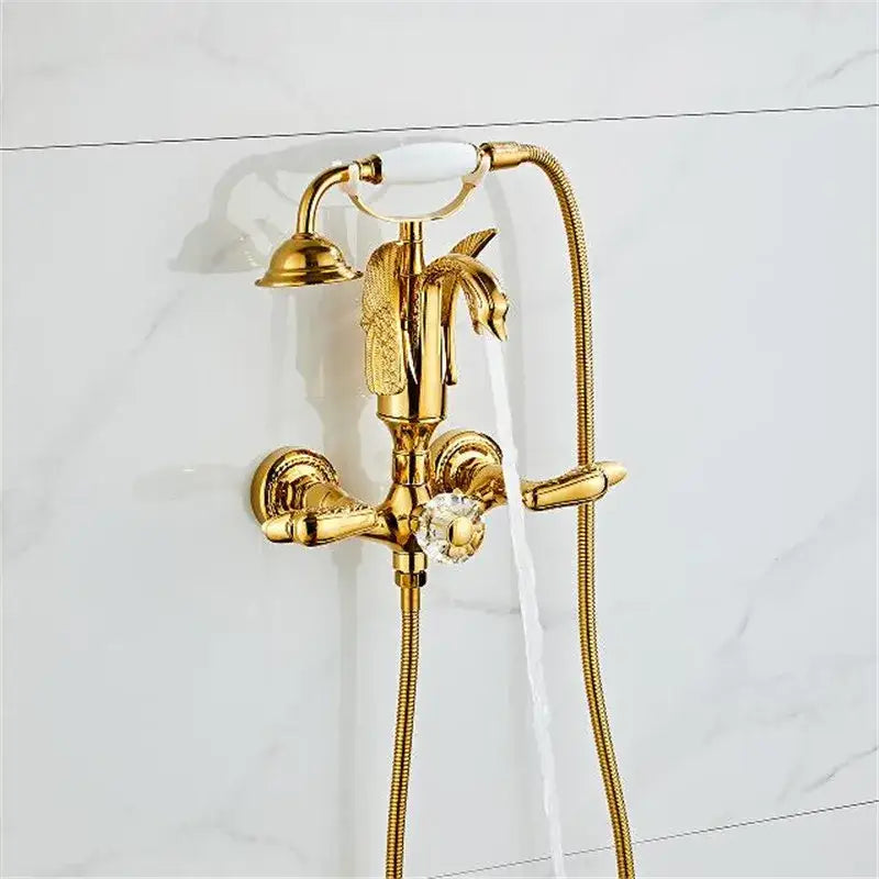 Gold swan bathtub faucet set in gold finished brass with ornate leaf detailing crystal knob and white ceramic handle by decorbites