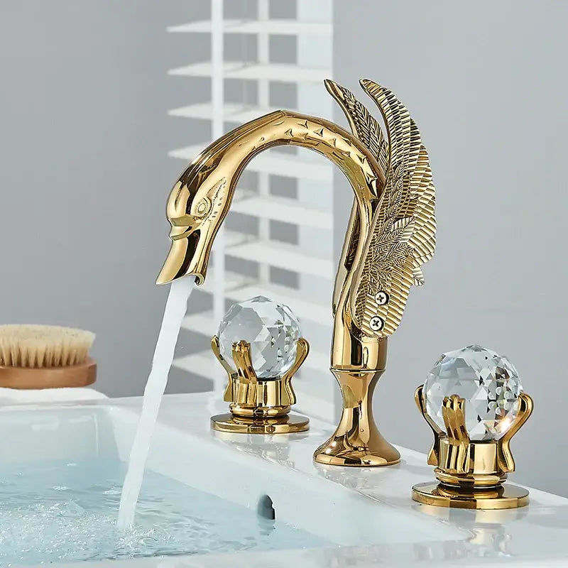 Gold swan crystal handle bathroom faucet with intricate feather detailing and crystal globe handles by decorbites gold swan