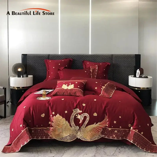 Red satin bedding set with intricate gold embroidered swan and star patterns and decorative lace trim for decorbites gold swan love