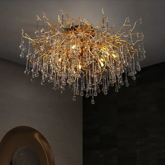 Gold tree branch chandelier with crystal droplets in gold style designed for elegant dining room lighting