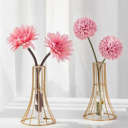 Gold vase with metal flowers featuring a wireframe design and clear glass inserts for modern desk decoration