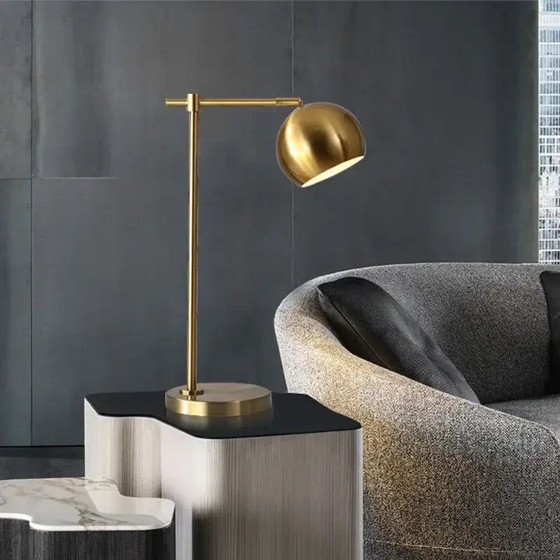 A sleek gold vintage industrial desk lamp with a spherical led shade ideal for bedroom decorbites decor