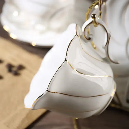 A delicate white bone china cup set with gold wave trim and curved handle from decorbites gold wave collection