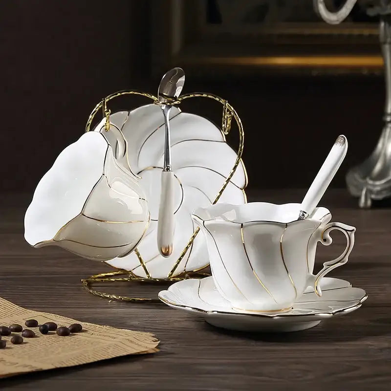 Elegant white bone china gold wave cup set with gold trim and leaf-shaped sugar bowl on ornate golden stand decorbites gold wave