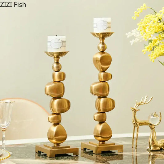 Golden alloy stone pile candle holder with stacked stone design and sleek metallic finish for living room decorbites decor