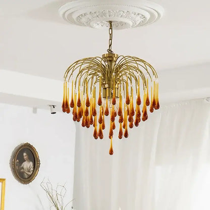 Golden amber crystal water drop chandelier with clear glass teardrop pendants on brass frame for dining room light