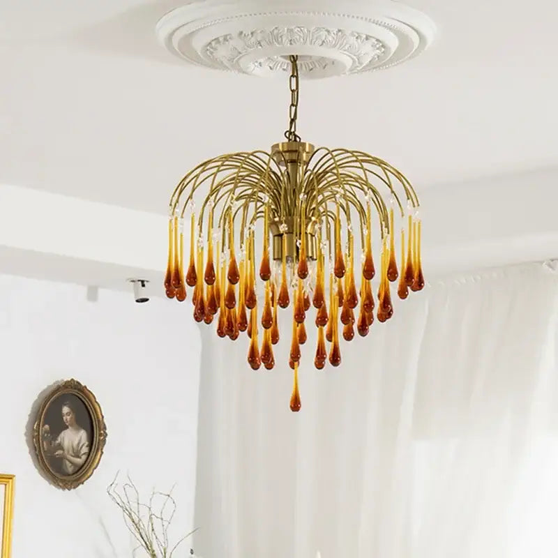 Golden amber crystal water drop chandelier with clear glass teardrop pendants on brass frame for dining room light