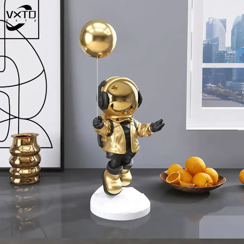 Golden balloon astronaut resin figurine with reflective metallic finish for modern resin home decor living room display