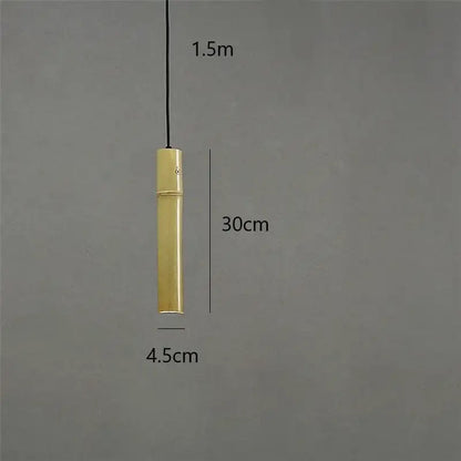 A sleek cylindrical brass tube pendant light with a minimalist design and 1.5 meter cord for dining room use