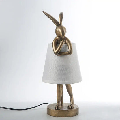 Golden bathing rabbit resin table lamp with white fabric shade for bedroom decor by decorbites bathing rabbit