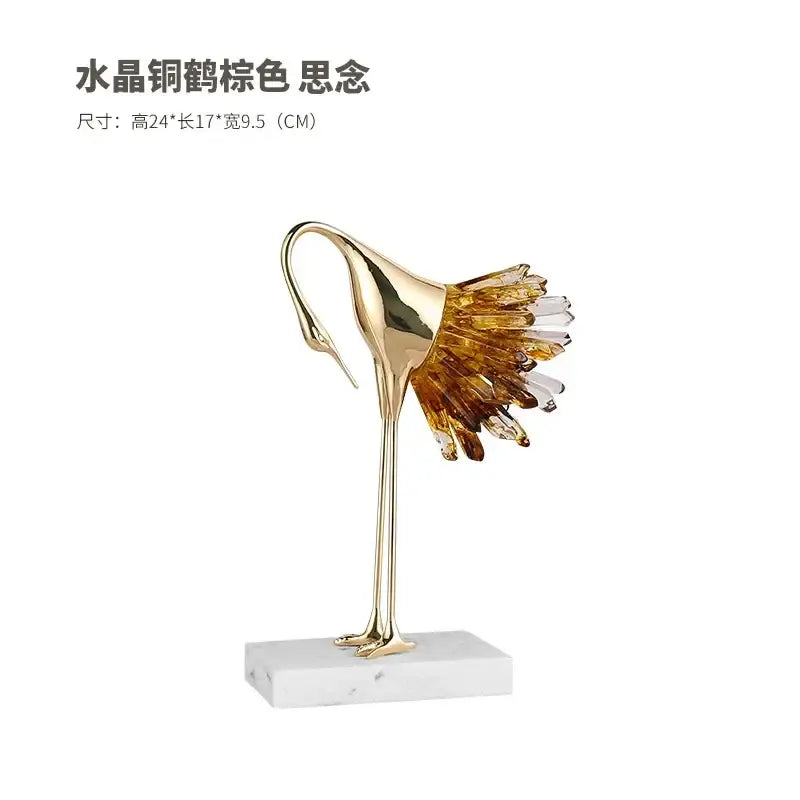 Golden bird agate marble crane statue with translucent amber and clear crystal wings on white marble base for home decor