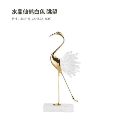 A sleek gold-toned bird agate marble crane statue with crystalline white feathers on a marble base for home decor