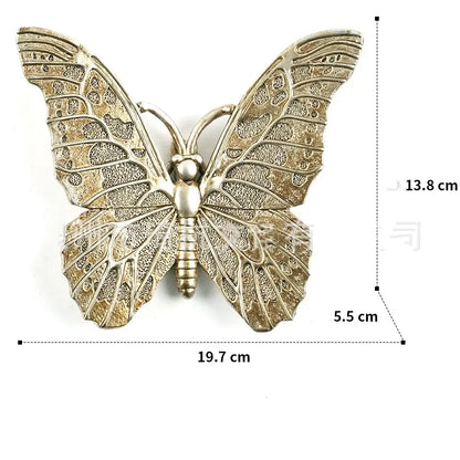 Antique gold-toned metal butterfly wall decor with intricate lace-like wings in decorbites golden bird butterfly resin wall collection
