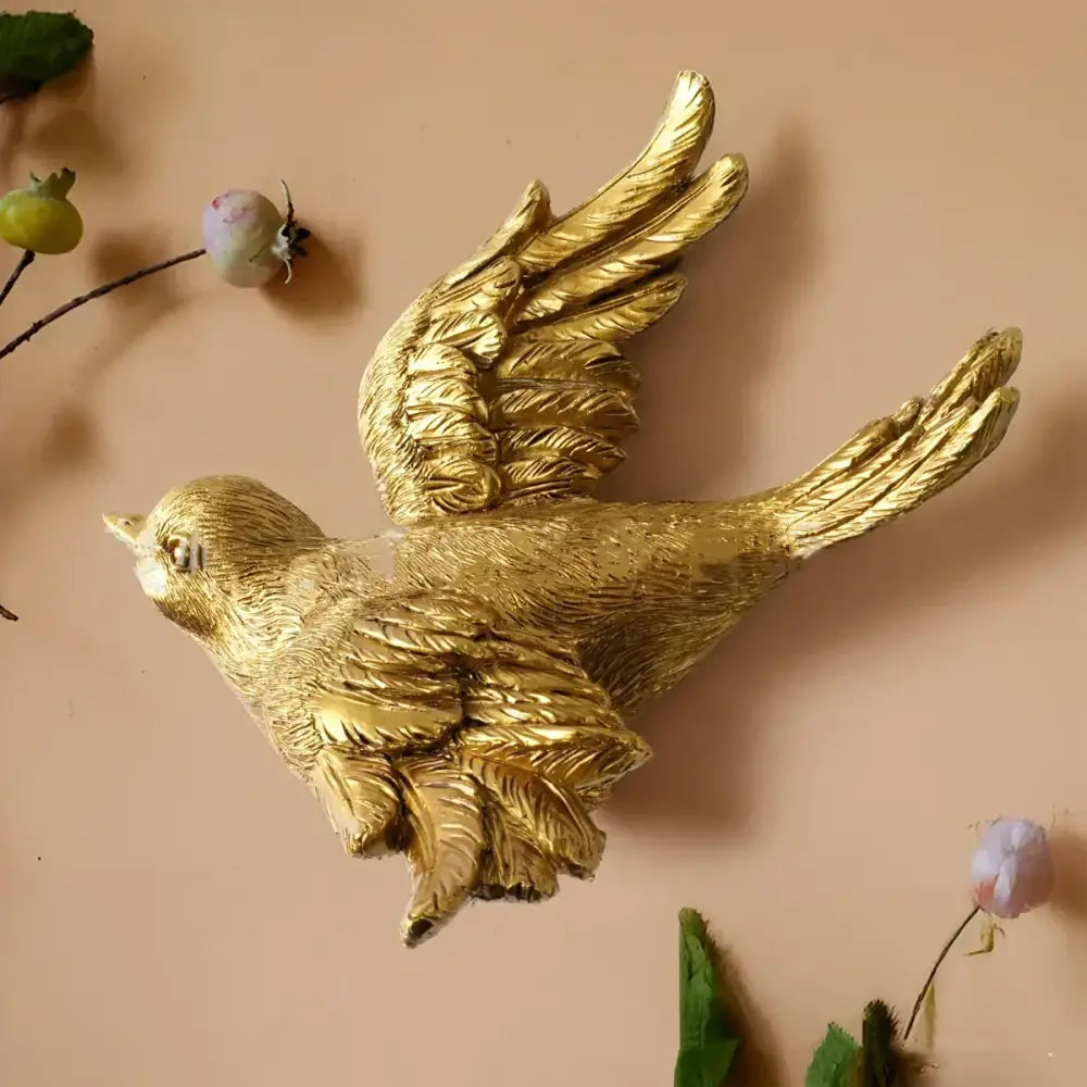 Golden bird and butterfly resin wall decor featuring detailed feathered wings with a sleek metallic finish for living room
