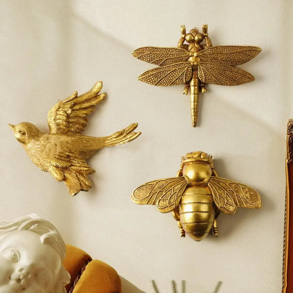 Golden bird and butterfly resin wall decor featuring detailed golden metallic dragonfly bird and bee for living room