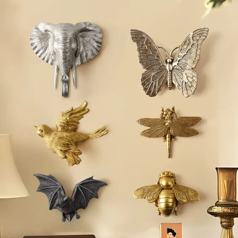 Silver and gold metallic wall decor featuring golden bird butterfly resin wall elements for living room display