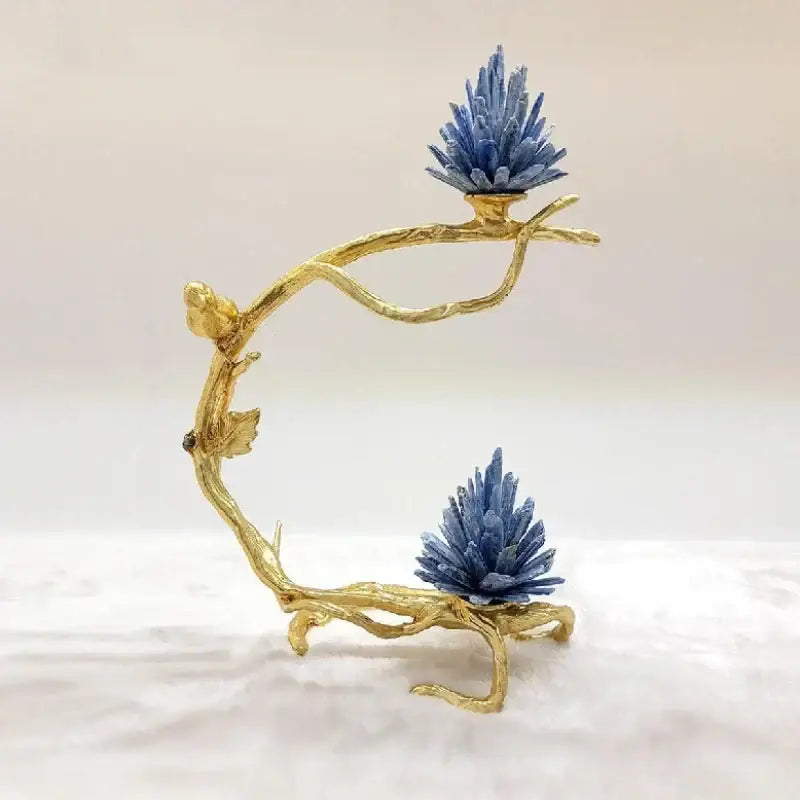 Golden bird metal branch sculpture with a golden stand holding two vibrant blue crystal clusters for living room decor