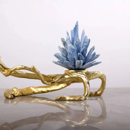 A golden bird metal branch sculpture features a striking blue apatite crystal cluster on a sculpted golden base