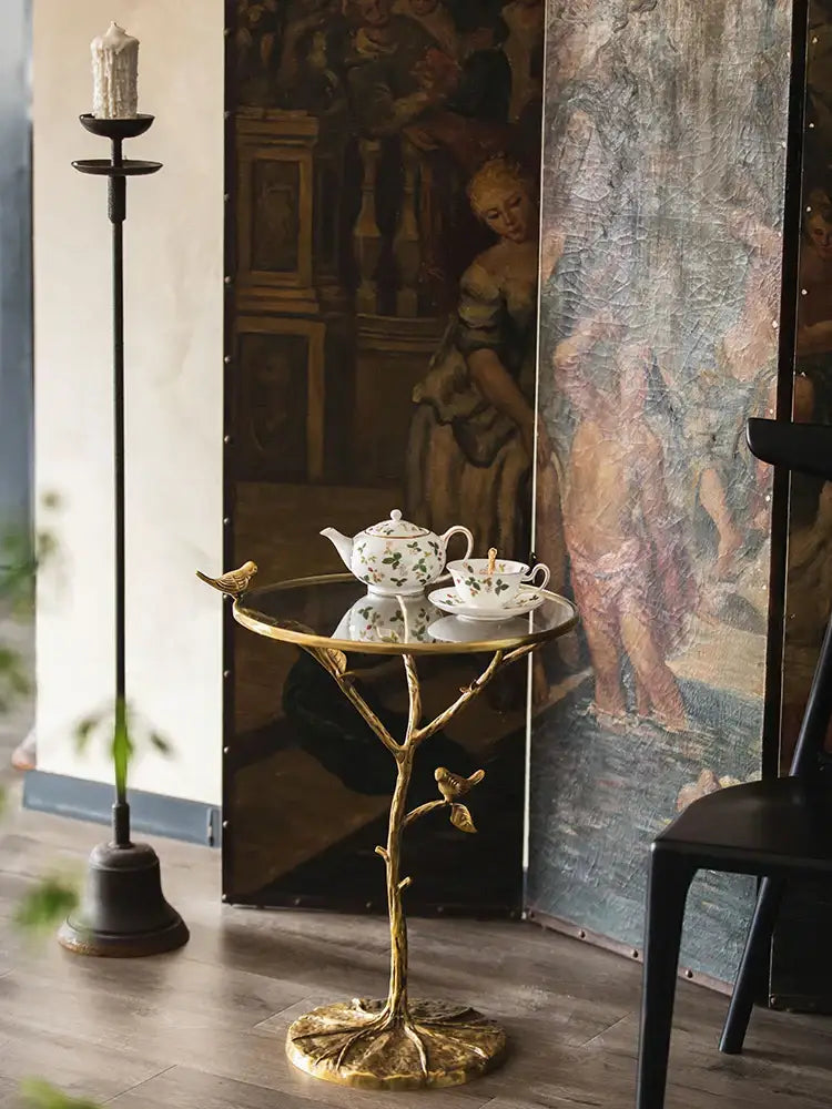 Golden brass bird tree side table with glass top and decorative birds for living room decorbites brass bird design