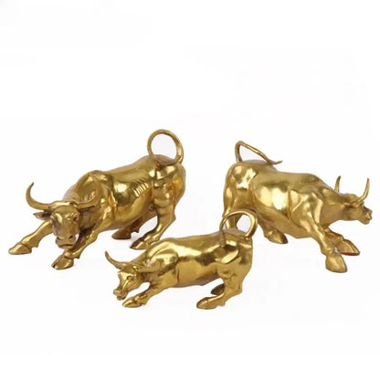 Three golden brass bull figurine sculptures with polished metallic finish and detailed musculature for office decorbites decor