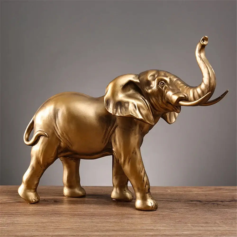Golden brass elephant resin sculpture with detailed features and raised trunk for living room decorbites elephant resin decor