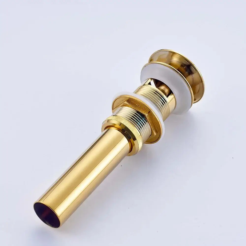Golden brass vintage bathroom sink pop up drain with gold-toned metal and white ceramic accents for decorbites golden brass decor