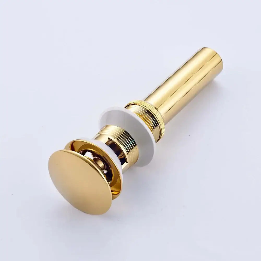 Golden brass vintage bathroom sink pop up drain with sleek gold-toned brass finish and white rubber gasket by decorbites