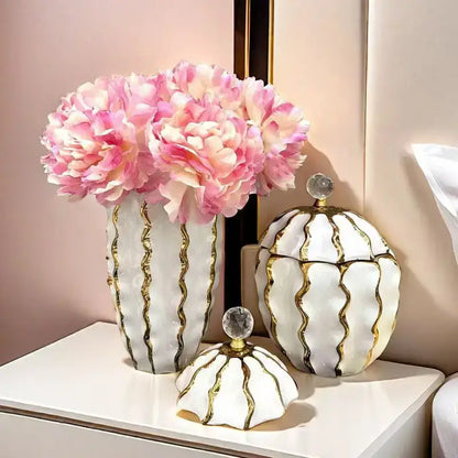 White ceramic vase with gold wavy stripes and crystal knob holding pink peonies for decorbites golden checkmate living room decor