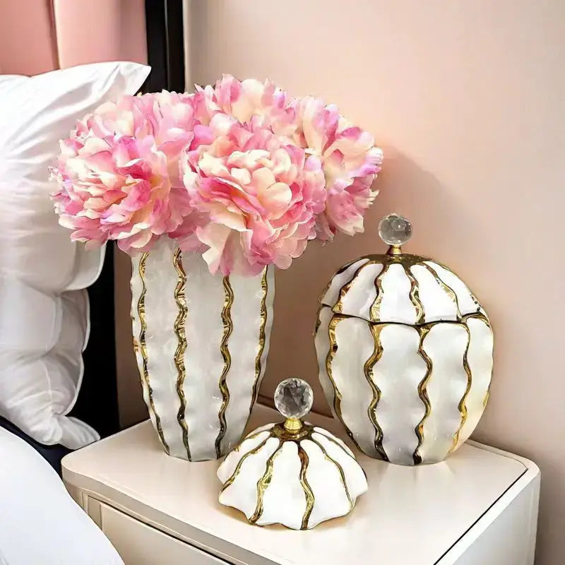 White ceramic decorbites golden checkmate jar with gold wavy stripes and crystal knob holding pink peonies for living room