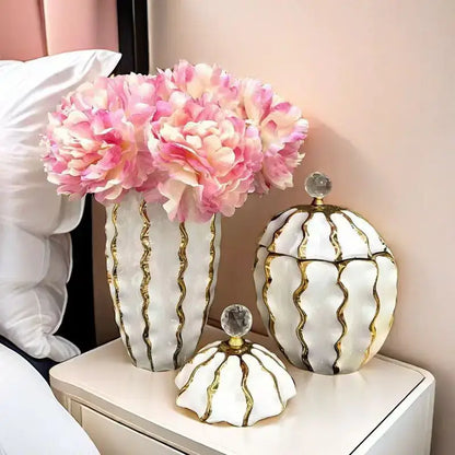 White ceramic decorbites golden checkmate jar with gold wavy stripes and crystal knob holding pink peonies for living room