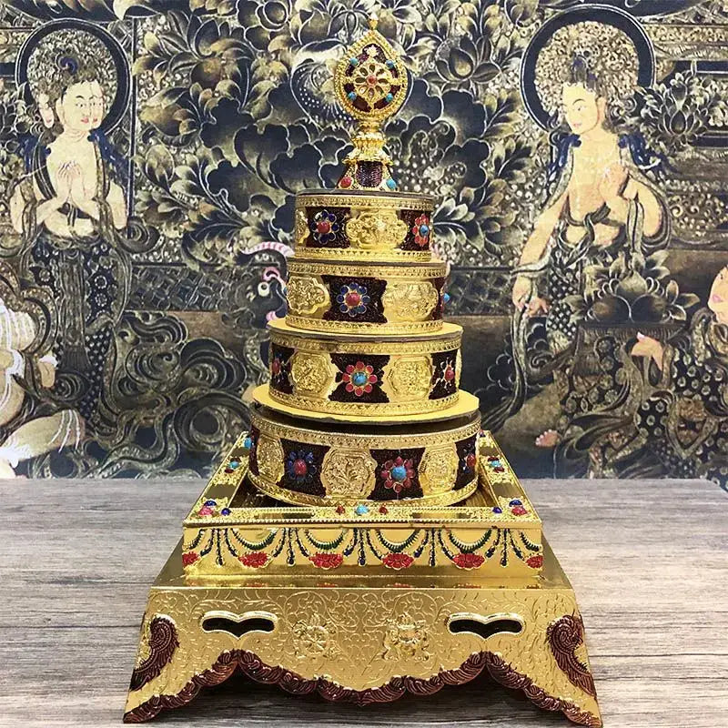 Golden eight auspicious buddha alloy plates featuring a golden tibetan prayer wheel with embossed patterns and gemstone inlays