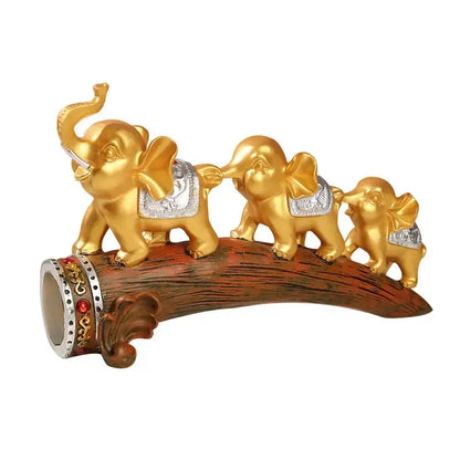 Golden elephant resin ornament with silver saddle accents on curved wooden log base decorbites elephant resin decor