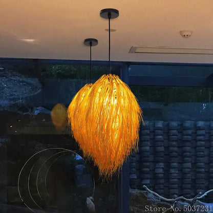 Golden feathery bamboo weave pendant lamp with warm glow and natural fiber construction for bedroom lighting