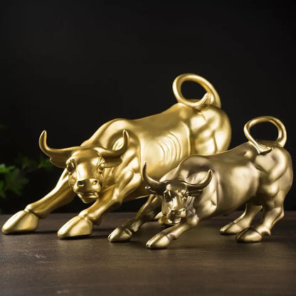 Two golden fortune resin sculpture bulls with detailed musculature and curled tails for office desk decor