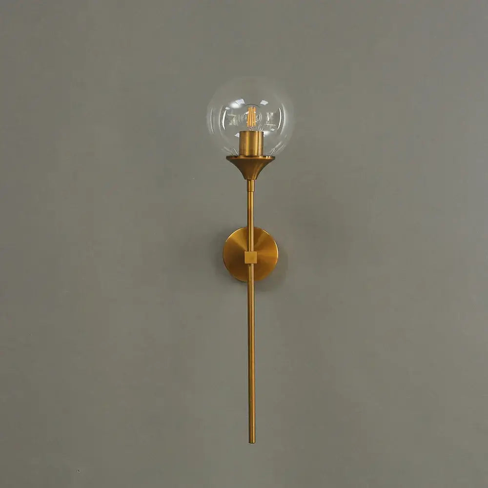 A sleek brass sconce with a clear glass ball LED light and exposed filament bulb for bedroom decorbites golden glass