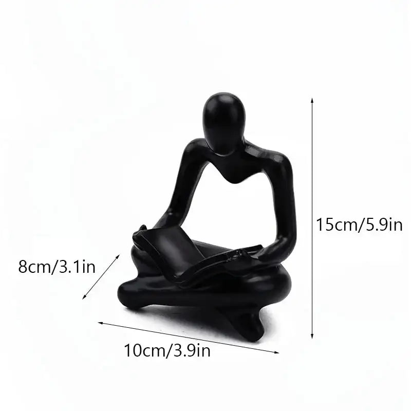 Black glossy resin figurine of a seated human reading a book for decorbites abstract thinker resin office decor