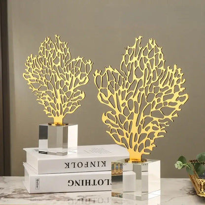 Two golden hollow tree coral sculptures with intricate cut-out patterns on clear acrylic bases for living room decorbites decor