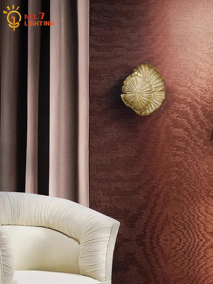 Gold-colored leaf-shaped designer copper wall lamp with textured surface for decorbites designer copper bedroom light decor