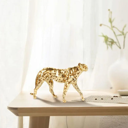 Golden leopard cheetah metallic sculpture with intricate spotted pattern in polished gold for living room decor