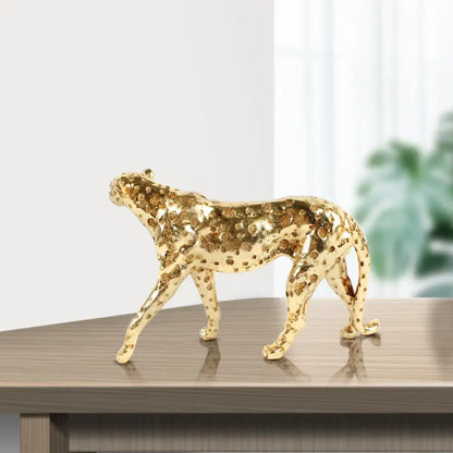Golden leopard cheetah animal sculpture with intricate raised circular patterns in gold for living room decor