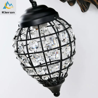Black metal cage wall lamp adorned with clear faceted beads from decorbites king crystal for king crystal wall decor