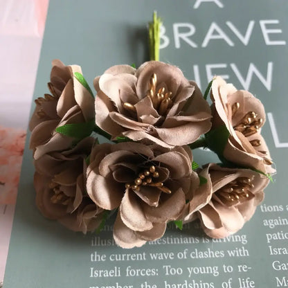 A delicate cluster of beige fabric roses with gold berry stamen and green stems for decorbites green plant decor