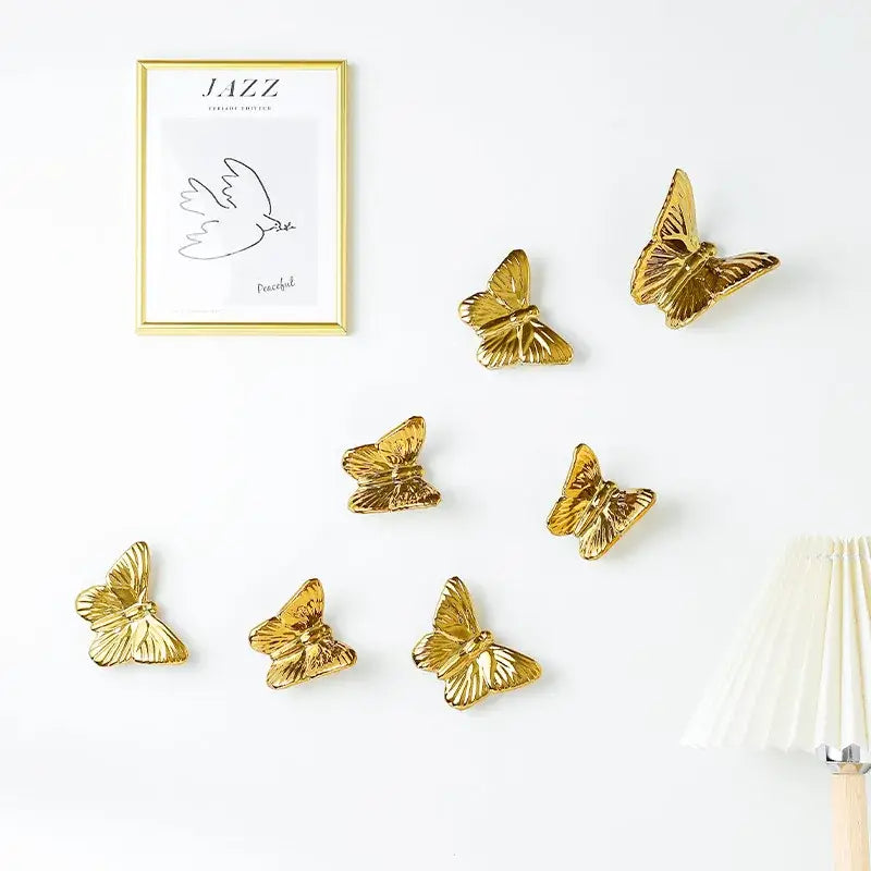 Gold-colored ceramic butterfly wall decoration set featuring metallic finish for living room wall decor set