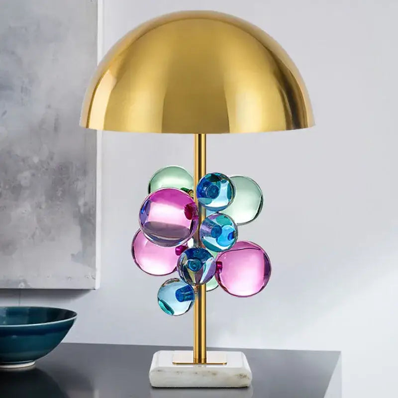 A modern table lamp with a polished gold dome shade and colorful glass orbs decorbites golden mushroom crystal ball table lamp